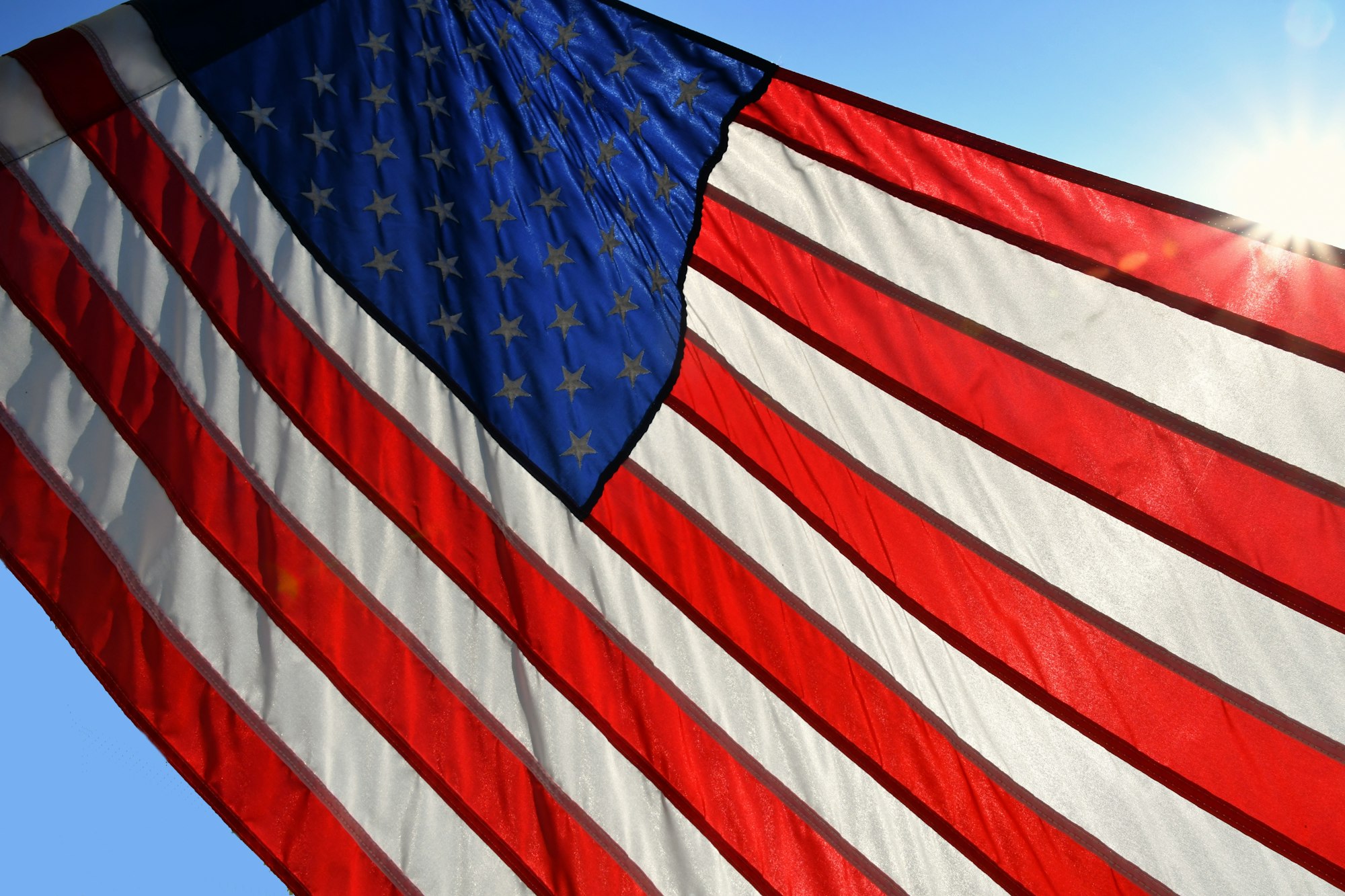 The flag of the United States of America. Old Glory. American flag with a sun flare.